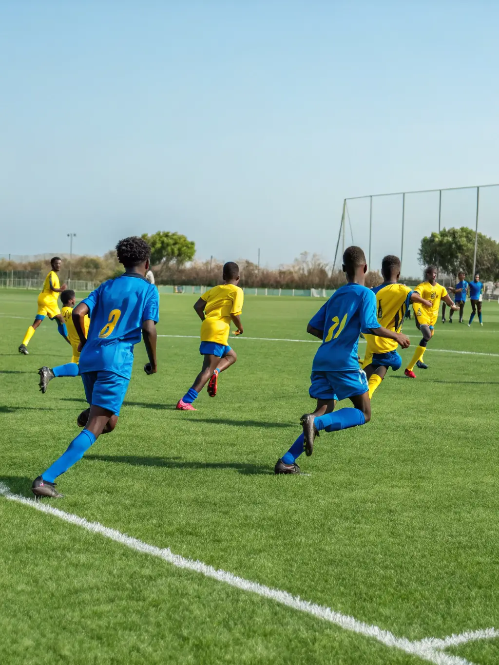 Students participating in a football match on the school field, showcasing the competitive spirit and physical activity promoted by ASJA.